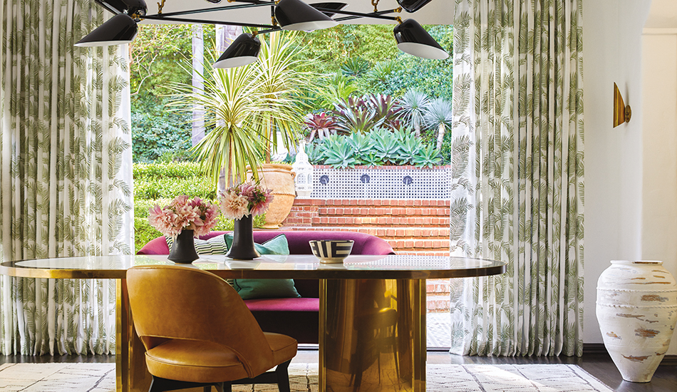 Floral patterns, one of the window treatment trends, is seen in this dining room's palm pattern Tailored Pleat Drapery