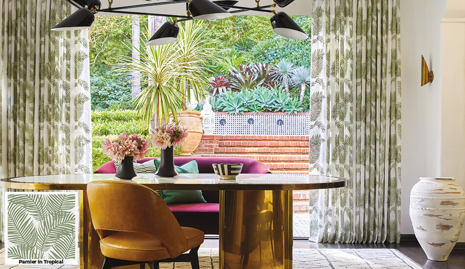 Floral patterns, one of the window treatment trends 2024, is seen in this dining room's palm pattern Tailored Pleat Drapery