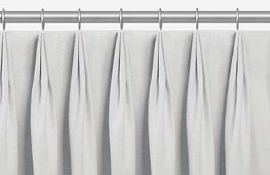 An example of drapery styles shown in a product image of tailored pleat drapery with three-fingered pleats pinched at the top