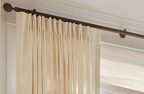 A close up of silk curtains made of Raw Silk in Glacier in the Tailored Pleat show the elegance of the pleat style