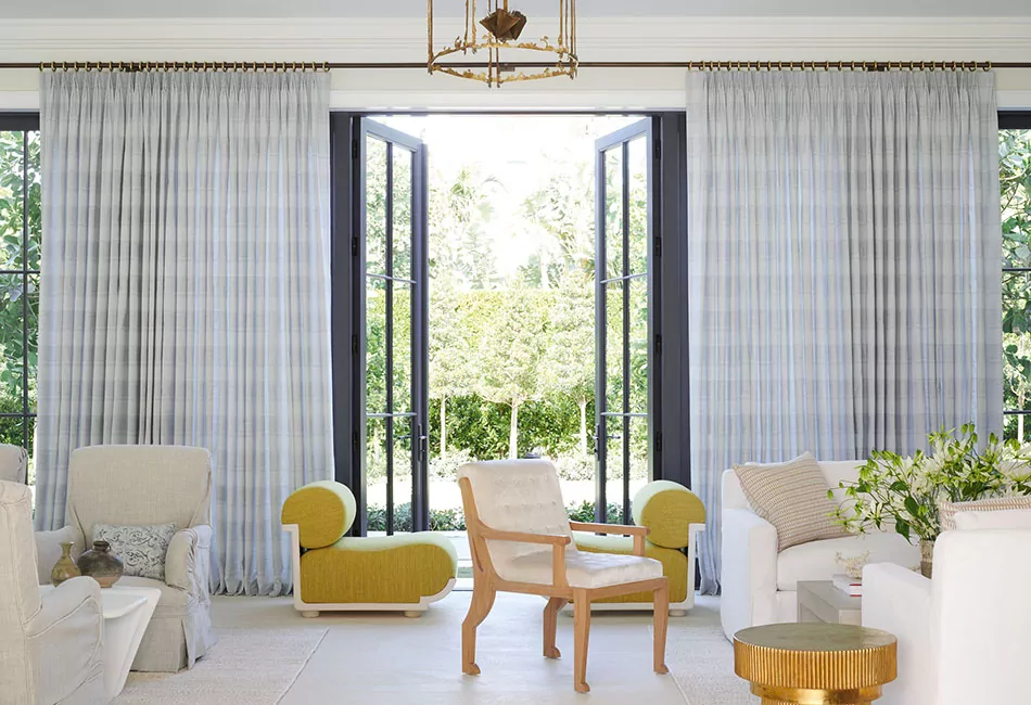 Glass doors open to let the outside in with tailored pleat drapes on either side showcase curtain ideas for living rooms