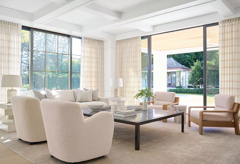 Living room curtain ideas for a bright room include tailored pleat drapes made of Victoria Hagan's Lily in Buff