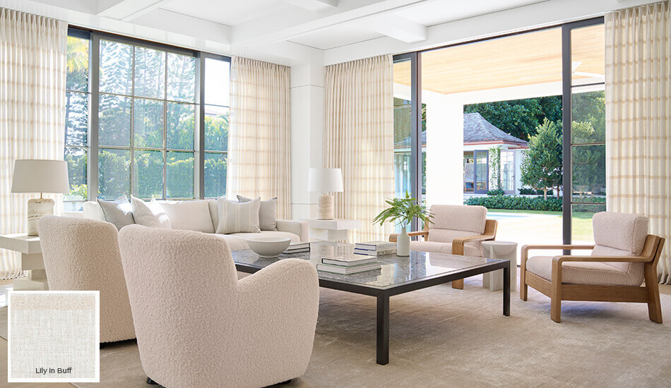 One of the colorful window treatment trends 2024 is the use of warm, light neutrals seen on these living room drapes