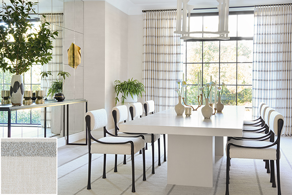 A modern dining room features Tailored Pleat Drapery made of Victoria Hagan's Lily in Silver for a subtle linear design