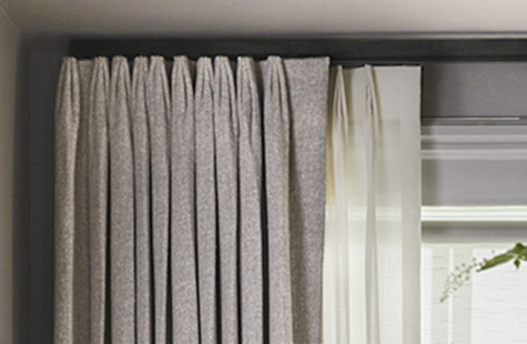 Example of how to hang double curtains featuring Tailored Pleat Drapery in Heathered Linen in Smoke and Wool Blend in Cloud