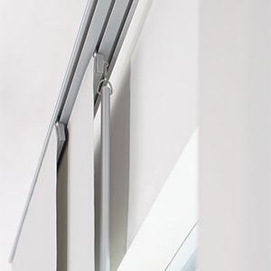 A close up of a baton control option for panel track blinds shows the thin metal baton behind the first panel
