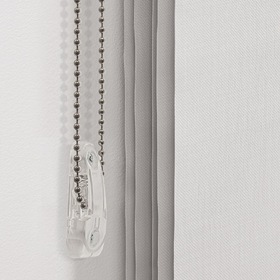 A close-up image of a cord draw system with the cord loop held in a tension device installed on the wall, showing how to close window blinds