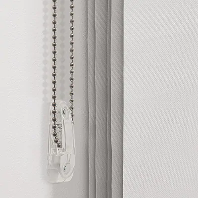 A close up image of a cord draw system with the cord loop held in a tension device installed on the wall