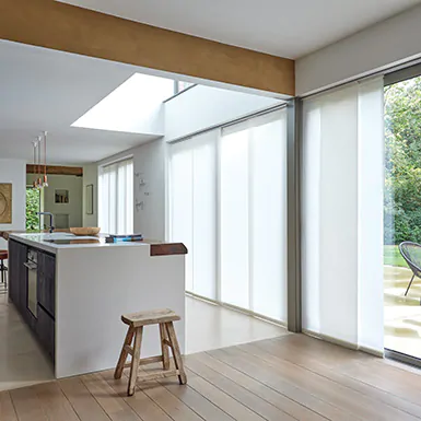 A mid century modern dining room features vertical blinds for tall windows made from Park material in Winter