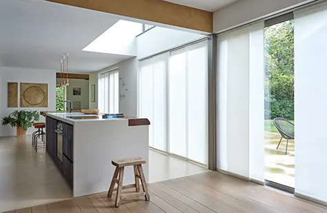 Vertical Blinds made of Park in Winter are used as window treatments for large windows in a mid-century modern kitchen