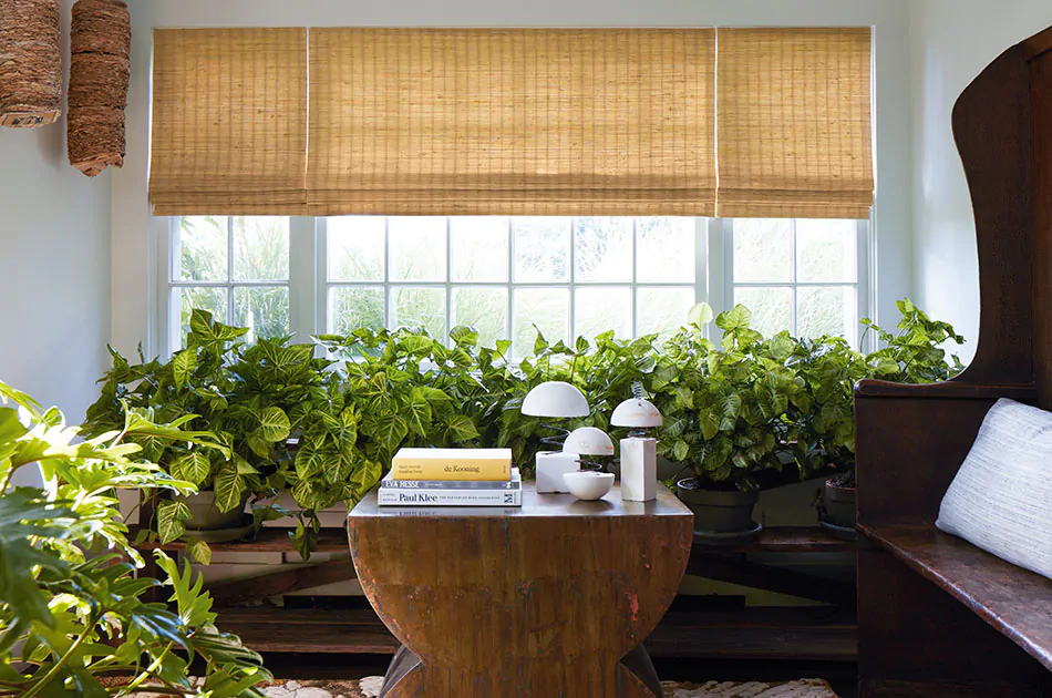 A sunroom features one of the types of window shades, woven wood shades which adds a warm organic element