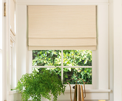 A Cordless Woven Wood Shade made of Somerset in Cloud warm ivory kitchen shows one style of pull down window shades