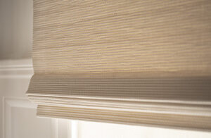 A close up of a Woven Wood Shade made of Artisan Weaves Somerset in Cloud shows the light honey color and woven texture