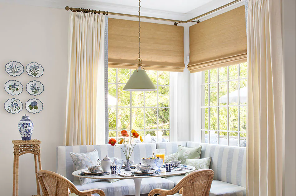 A breakfast nook with charming coastal aesthetic features corner window curtain made of Luxe Linen in Oyster