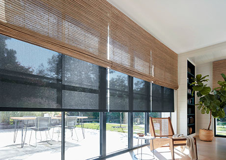 Window coverings in a modern space include Waterfall Woven Wood Shades made in Cove, Beige and Solar Shades in 10% Black