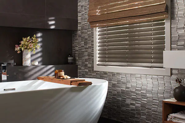Bathroom window privacy for a bathroom with dark tiles is achieved with Wood Blinds made of 2-inch Bamboo in Black