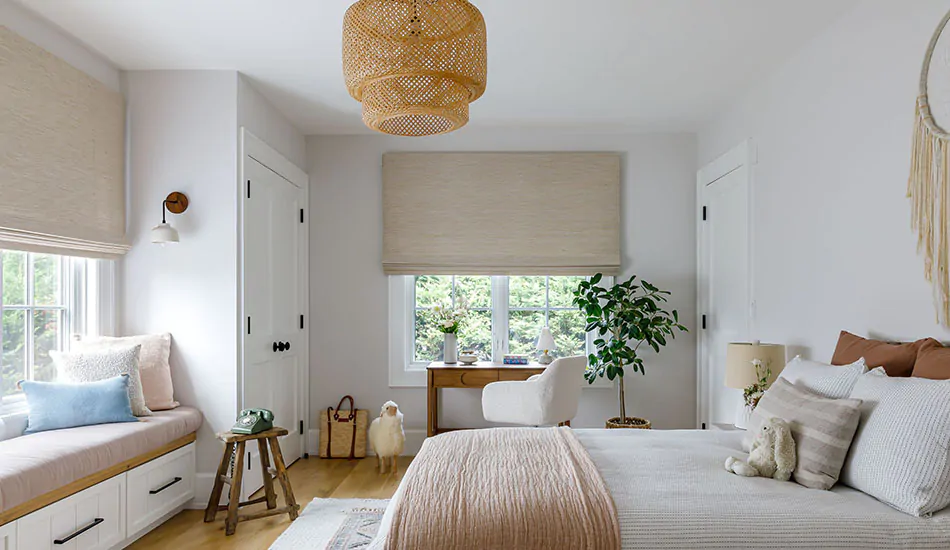 A window treatment buying guide will help you choose the right style like Waterfall Woven Wood Shades in a boho bedroom