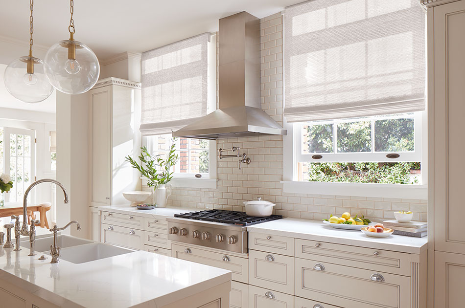 A bright kitchen has Flat Roman Shades made of Monterey in White showing how to install shades in kitchen windows