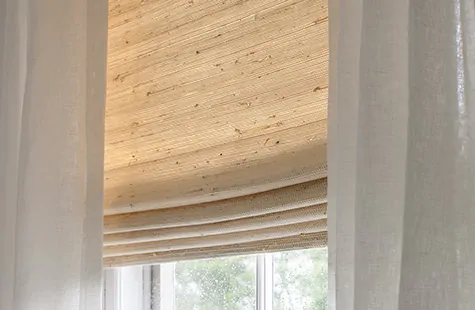 Window treatment trends 2023 include shades made from natural woven fibers and blinds made from sustainably sourced wood