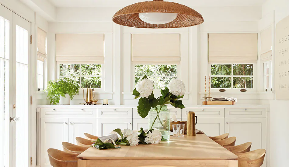 A boho-inspired modern farmhouse dining room features farmhouse window treatments of Woven Wood Shades in Somerset, Cloud