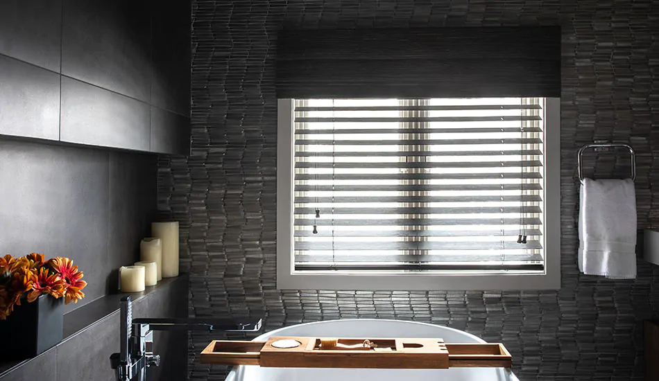 Bamboo Wood Blinds in Coal cast a dynamic silhouette on a bathroom window showing the difference between blinds vs curtains