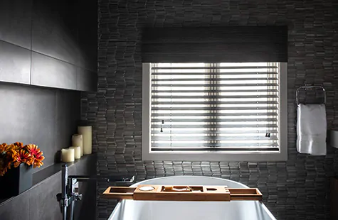 Inside mount blinds made of 2-inch Bamboo in black complement the dark, relaxing theme of the bathroom