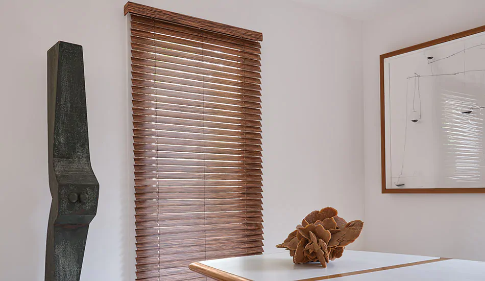 A dining room features exotic wood blinds for tall windows made of 2-inch exotic wood in Ebony, a dark wood tone