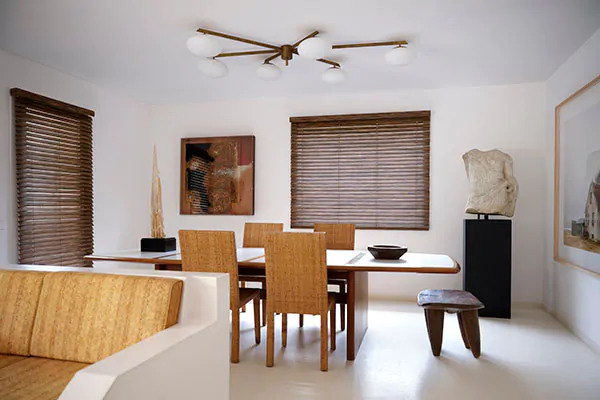 Wood Blinds made of 2-inch Exotic in Ebony offer a warm wood tone and visual texture to a mid-century modern dining room