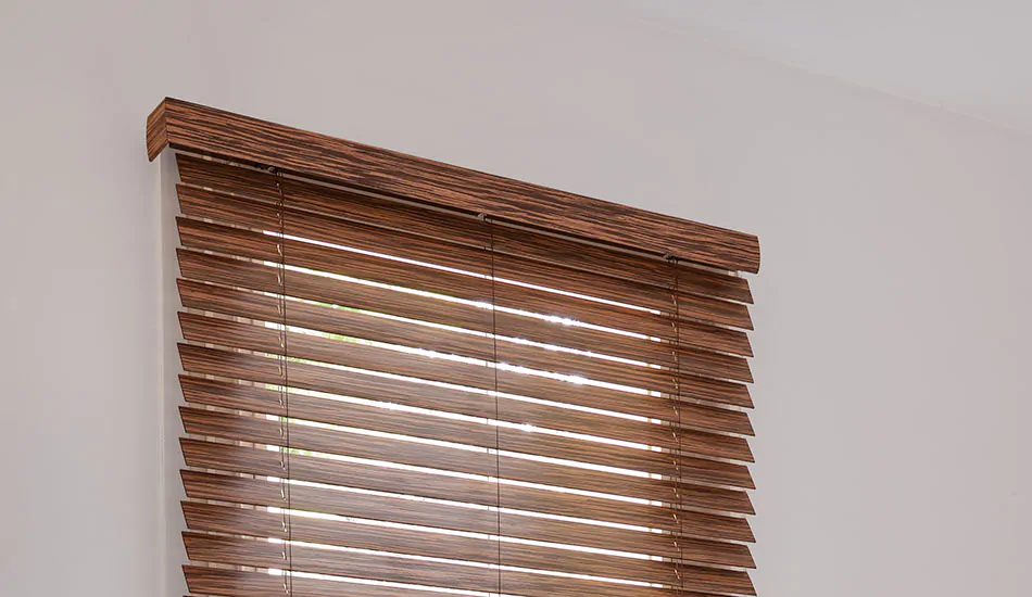 2-inch Wood Blinds made of Exotic Ebony are installed with a valance that matches the slats on a tall window