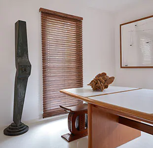 A mid century modern dining room features a tall window with Wood Blinds made of Exotic wood in Ebony