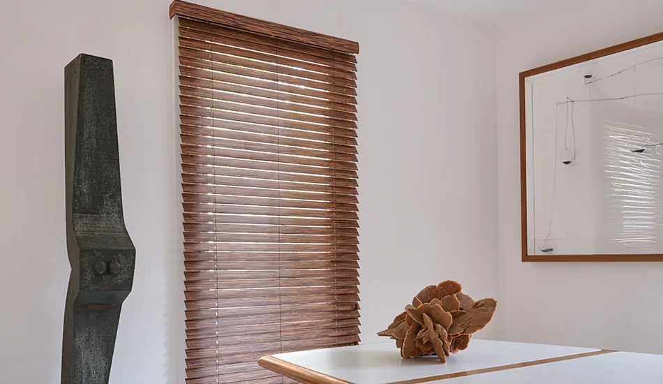 A dining room features exotic wood blinds for tall windows made of 2-inch exotic wood in Zebrano, a dark wood tone
