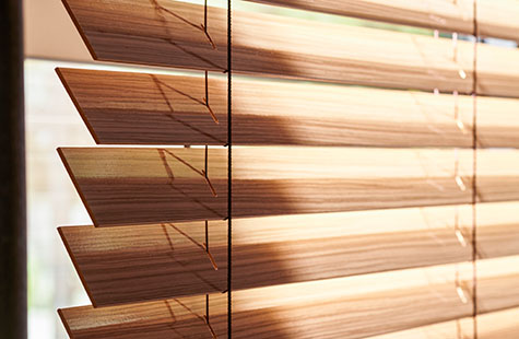 A close up of Exotic Wood Blinds in Zebrano shows the realistic, highly varied wood grain and rich warm color