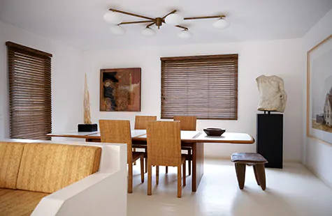Outside mount blinds made of Exotic wood in Zebrano offer a rich wood tone to a mid century modern dining room