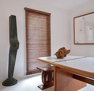 A mid century modern dining room features a tall window with Wood Blinds made of Exotic wood in Zebrano
