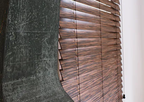 Small window blinds made of 2-inch Exotic wood in Zebrano add warm wood tones and visual texture to a dining room