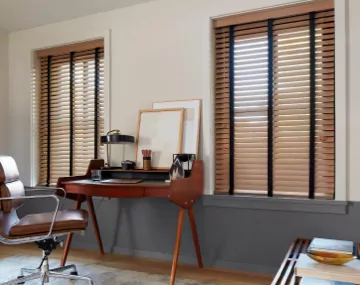 2 Inch Oak Wood Blinds hung over windows in an office with a centered wooden desk and brown office chair