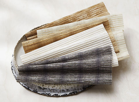 Woven Wood Shade swatches from the Artisan Weaves Collection are decoratively arranged to show their rich woven texture