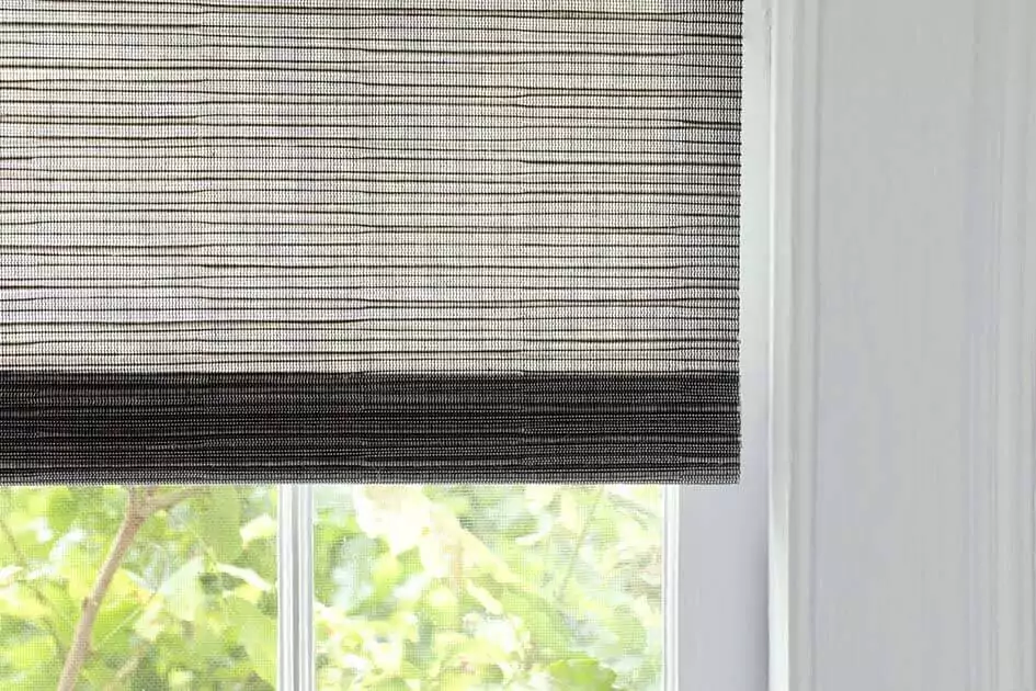 A close up of dark grey light filtering woven wood shades shows one option for shades for sliding doors
